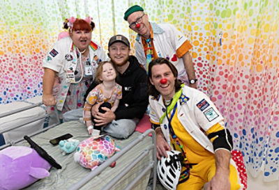 Jimmy Rees with the Clown Doctors and a patient