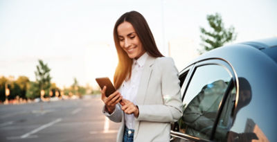 amily with electric car standing in front their house with solar panels on roof.
