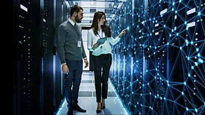 Engineers Discussing Technical Details in a Working Data Center