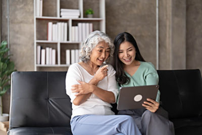 Couple at home sitting against couch