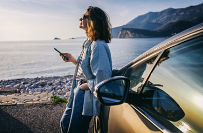 lady by a lake with car parked