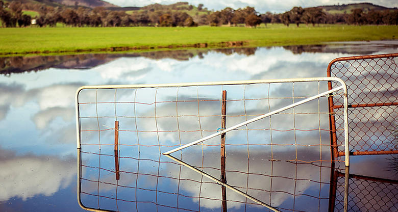 Farm gates and farm with dam flooded