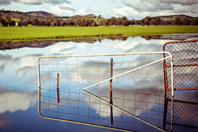 Farm gates and farm with dam flooded