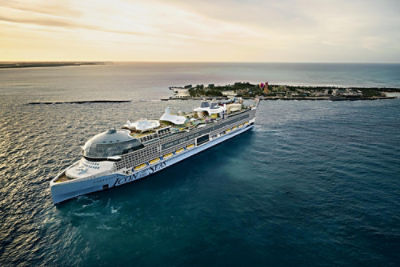 Royal Caribbean's Icon of the Seas cruise ship in the ocean in front of an island.