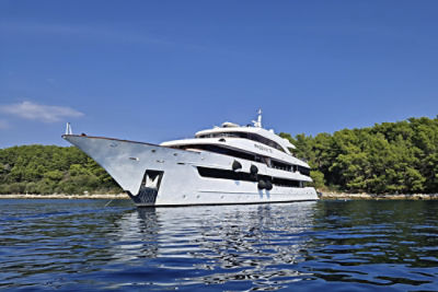 Unforgettable Croatia’s MS Phoenix cruise ship in the ocean in front of a coastal landscape.