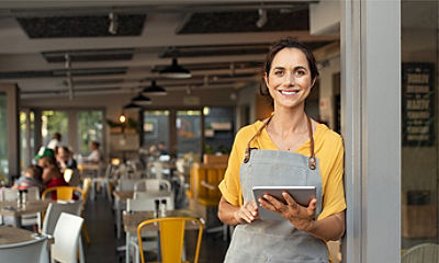 A woman standing by the table