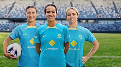 Ellie Carpenter, Steph Catley and Mary Fowler posing in blue CommBank jerseys