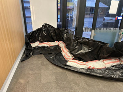 Bags of sand by the door of a CBA branch as preparation for ex-Tropical Cyclone Alfred