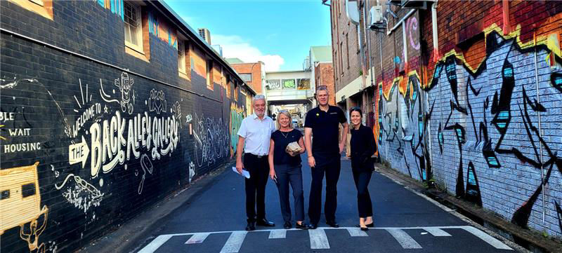 Four staff members from CBA Lismore branch smiling outdoors