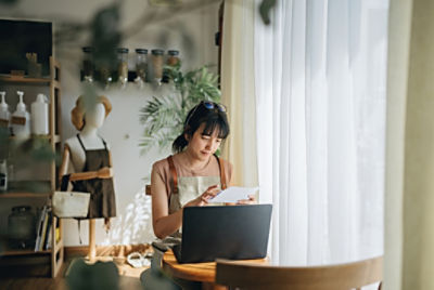 Woman sitting at a desk looking at her laptop