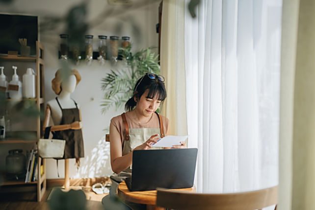 Image of woman reading end of financial year documents