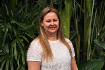 Janine Mergler standing in front of a garden.