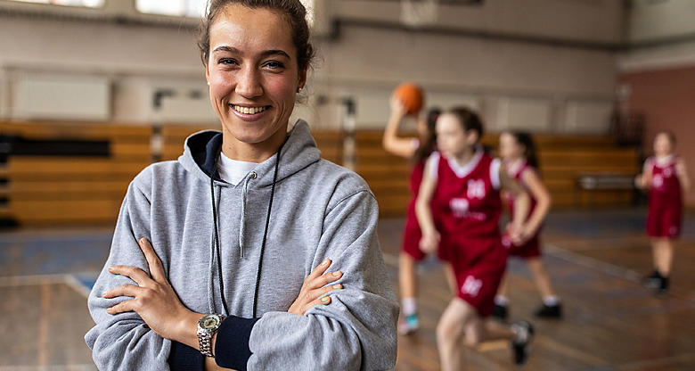 Female sports coach in grey jumper