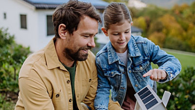 Adult showing child solar panel