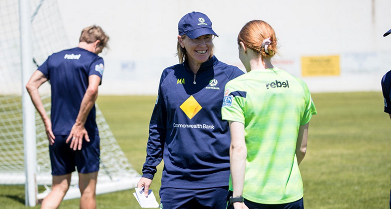 Melissa Andreatta, CommBank Matildas' Assistant Coach, smiling with a player at a training session
