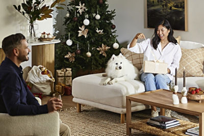 A couple sitting opening presents