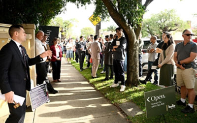 Auctioneer Jesse Davidson presides over a property auction in Homebush, in Sydney. Credit: AAP Image/Dan Himbrechts