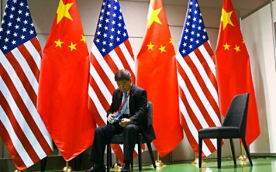 A Chinese official waits on a chair in the corridors outside a the bilateral meeting between Chinese President Xi Jingping and President of the United States of America Donald Trump at the G20 summit in Osaka, Japan. Credit: AAP Image/Lukas Coch 