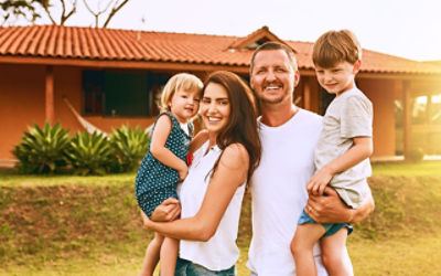 A family with Millennial-aged parents standing in front of a house. Picture: Adobe Stock 