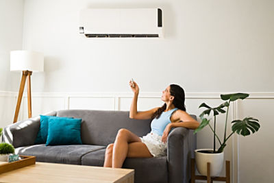 Woman under aircon unit