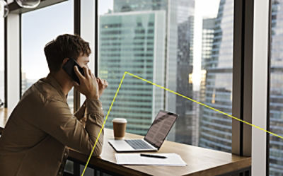 Man discussing investment strategies over the phone, reflecting the personalised, client-focused approach in bond market analysis.]