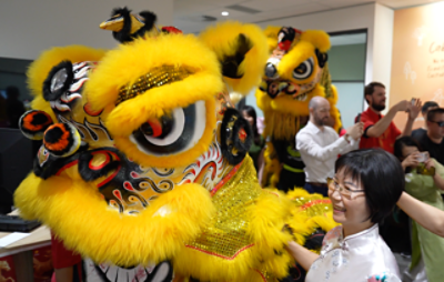 CommBank staff pose with a lion dancer at the Cabramatta branch Lunar New Year celebration. Photo: CommBank Newsroom