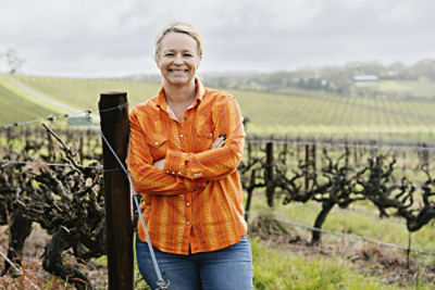 Oliver’s Taranga Vineyards director Corrina Wright standing in front of grape vines.