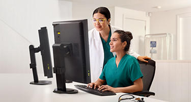 Image of a female doctor sitting in a chair at a desk