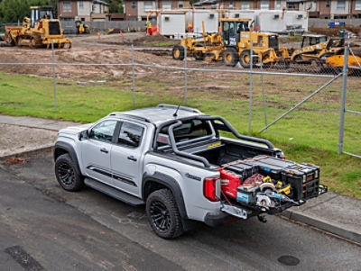 A ute with equipment tray parked next to a construction site