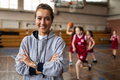 Female sports coach in grey jumper