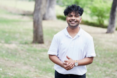 Sahel Mohammed standing in a park.