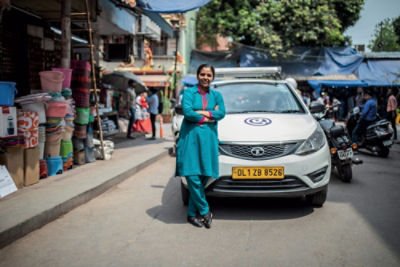 woman standing in front of car