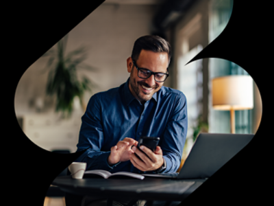 Business owner leaning against a tablet looking at a tablet