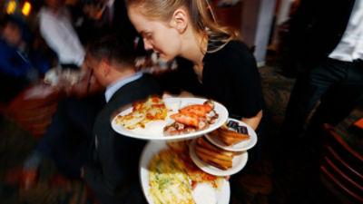  A waitress carries breakfast dishes to customers at a restaurant on Jan. 20, 2017, in east Denver, CO. Credit AAP/ AP