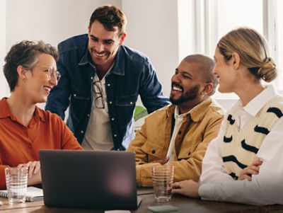 People around a computer. Credit: AAP