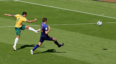FILE - In this June 18, 2014 file photo, Australia's Tim Cahill, left, scores his side's first goal during the group B World Cup soccer match between Australia and the Netherlands at the Estadio Beira-Rio in Porto Alegre, Brazil. Shortly after Australia fell behind 1-0 down, Cahill ran onto to a looping pass from Ryan McGowan and hit a perfectly-timed volley with his weaker left foot from about 11 yards out. (AP Photo/Michael Sohn, File)