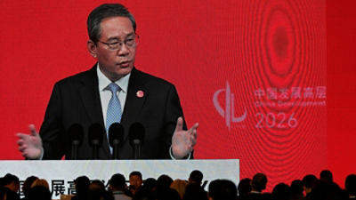 Chinese Premier Li Qiang is displayed on a large screen live broadcasting his speech at the opening of the China Development Forum 2026 held at the Diaoyutai State Guesthouse in Beijing on Sunday, March 22, 2026. (AP Photo/Ng Han Guan, Pool)