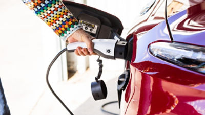 Person charging an EV car
