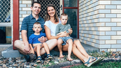 Family sits at their front door