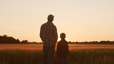 A father and son on a rural property. Image: Adobe stock.