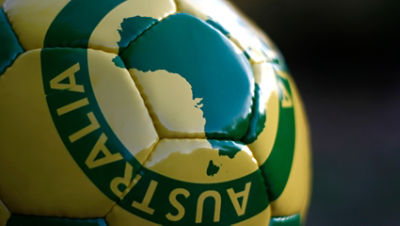 Green and gold football with Australian map pictured on it.