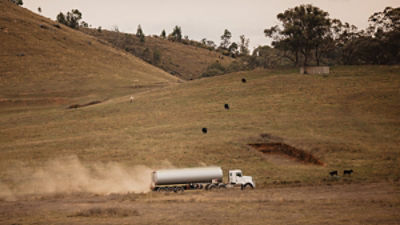 Fuel tanker truck driving along rural country road. Credit: Austockphoto/ Adobe Stock