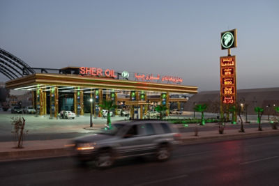 A car drives past a service station in Iraq.