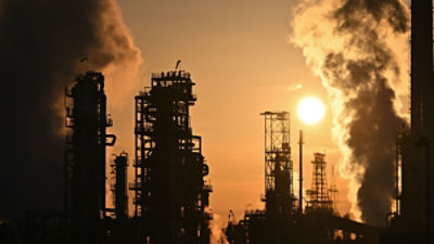 Facilities of the Mineralölraffinerie Oberrhein (MiRO) can be seen against the light. The refinery is one of the most important mineral oil processing sites in Germany