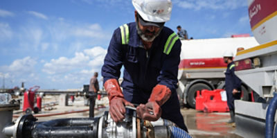 A worker fills Iraqi tanker trucks with gasoline at the Baniyas oil terminal in Syria's Tartus province. The fuel is being transported to Iraq via Syria for the first time amid disruptions to shipping through the Strait of Hormuz. Photo: Moawia Atrash/dpa/Sipa USA