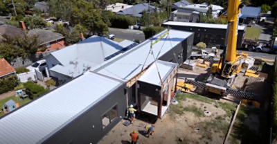 A factory-built home being installed on-site. 