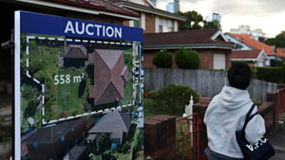A person walks past an auction sign outside a property in Sydney, Australia, June 22, 2026. REUTERS/Hollie Adams