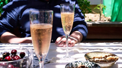 Generic image of glasses of prosecco on an outdoor dining table. Credit: Rowena Naylor/Stocksy