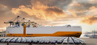 Cars and a ship at a port. Image: Adobe Stock