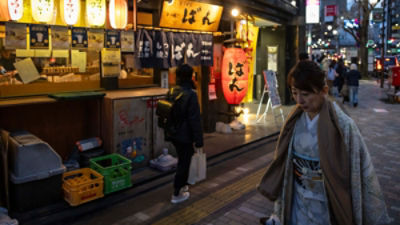 A woman walks down a street in Tokyo. Picture: AAP